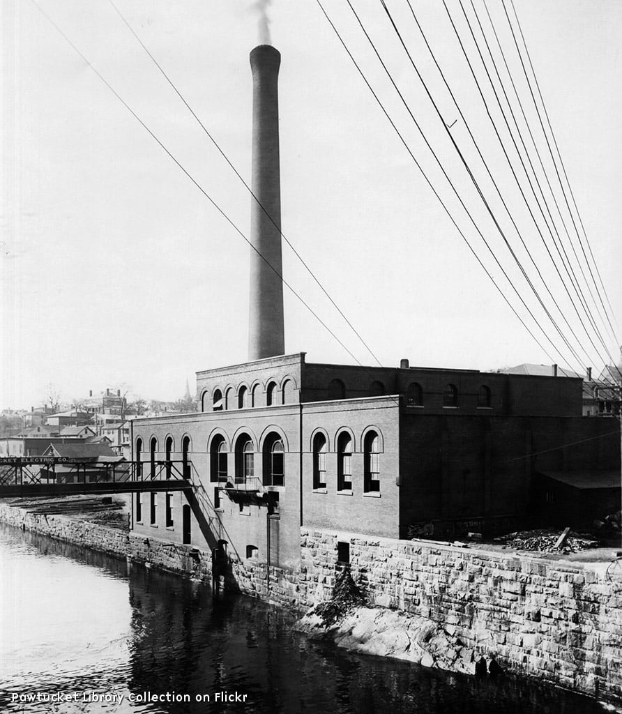 A rectangular red brick, two-story mill housing hydroelectric machinery to capture power from the nearby Blackstone River at the falls under Main Street, Pawtucket. MOst existing window openings are half round arch topped and a row of former windows along the southern side are the same style but bricked in. The interior is now used for a water power museum, with many old pieces of equipment inside. 