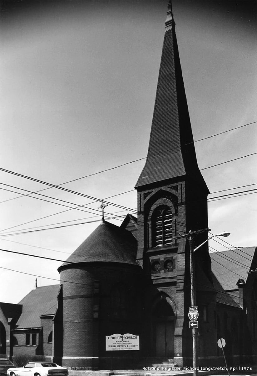 An asymmetrical church red brick building with dark brown granite ornamentation. A bell tower was offset from the semi-circular nave, while the interior was in poor repair, with exposed stick work and a frescoed ceiling as ornament.