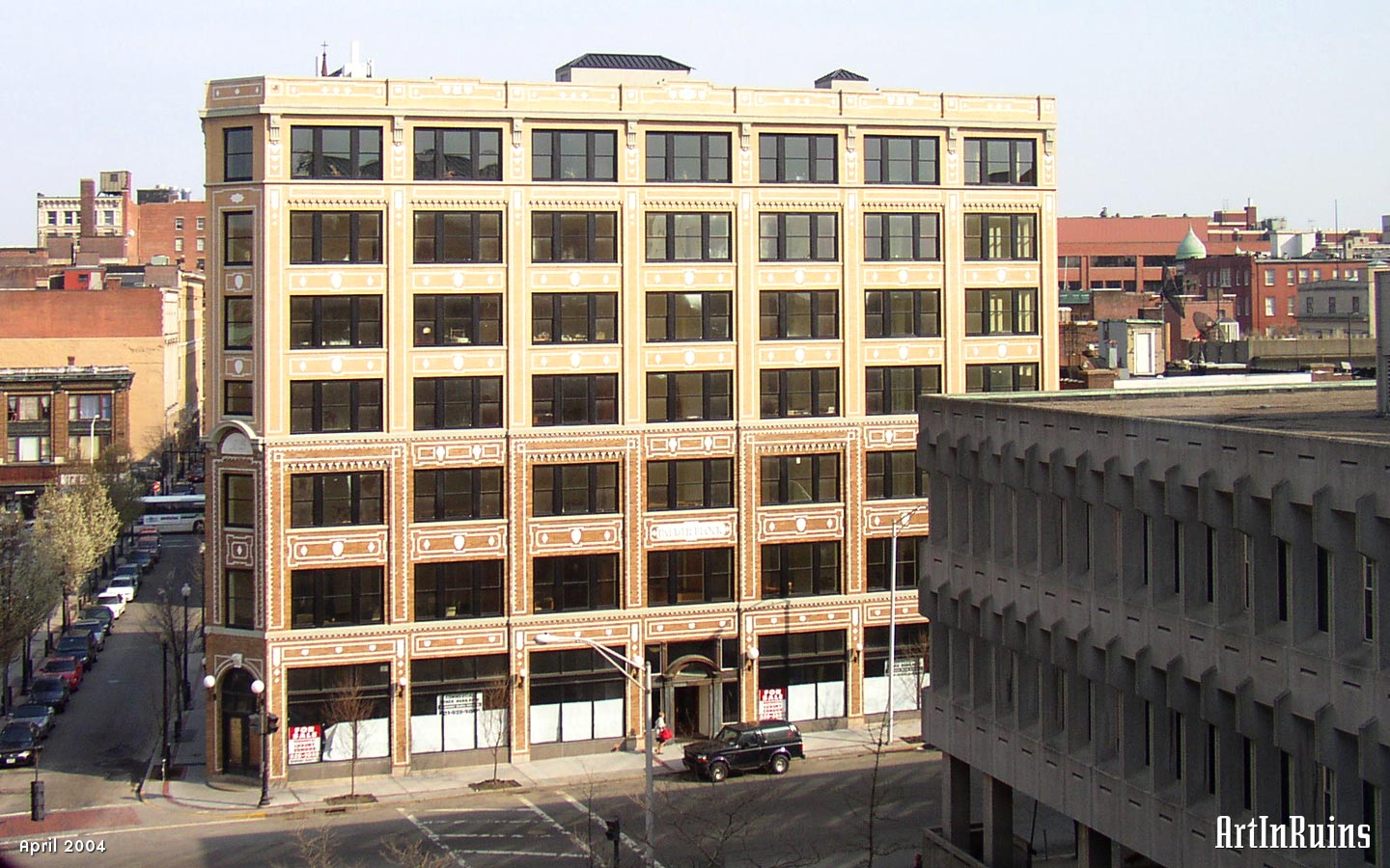 Yellow and white brick patterns in the facade of this building are geometric and ornamental. The first three stories are a darker yellow brick color than the upper four stories. The decorative designs stop at the top of the third floor and then start again, further indicating that these two sections were built at different times.