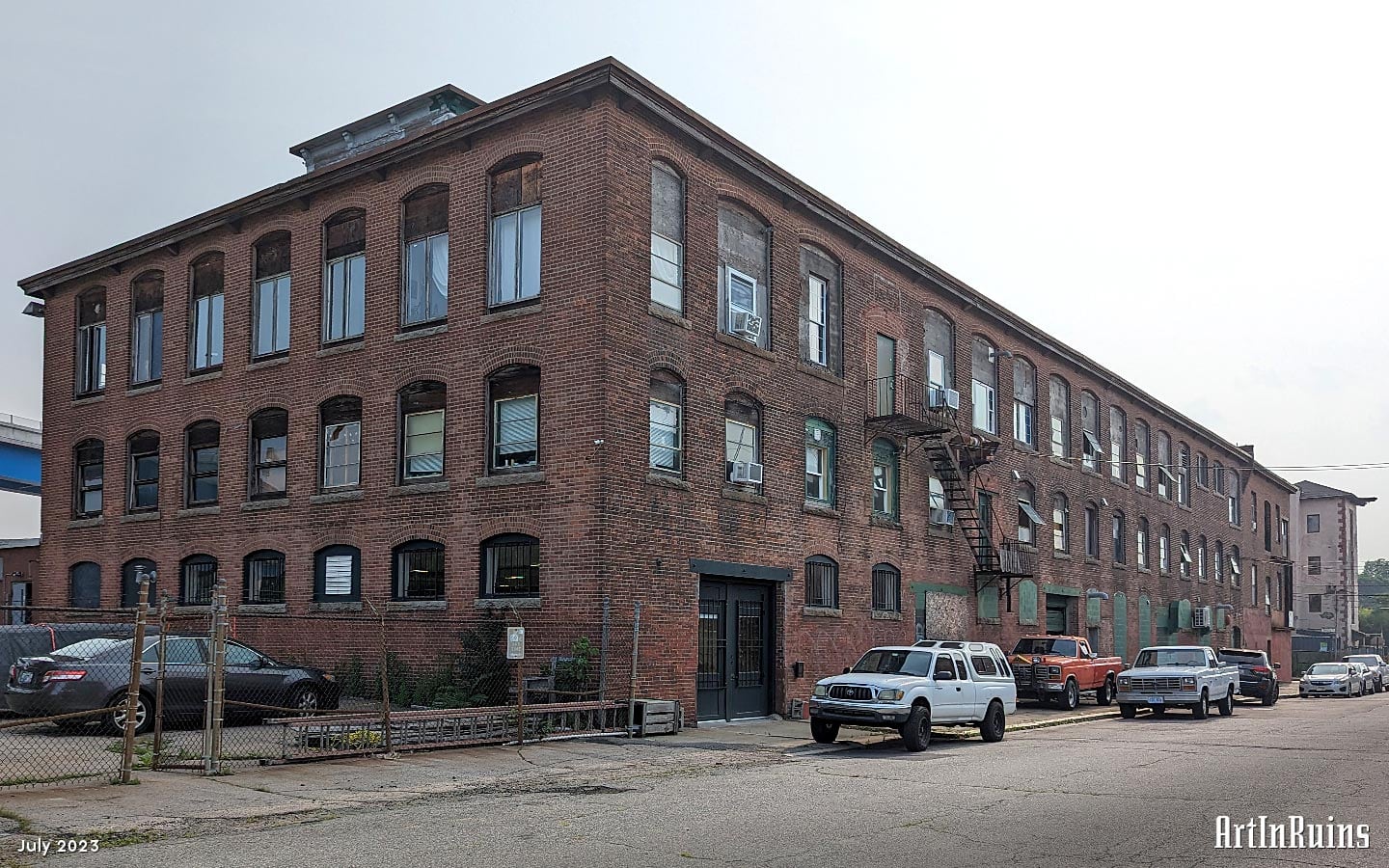 A large, three story red brick mill building with attached Boiler House and a raised monitor roof. An extensive architectural description is in the history section of the page.